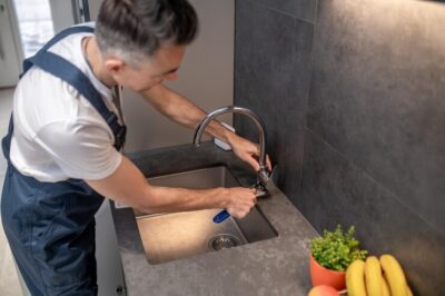 man adjusting water tap with wrench 259150 58269