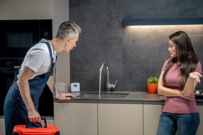 woman with question gesture plumber looking broken faucet 259150 58296